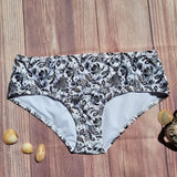 Bottom de Bikini CIntura Alta Niña DESIRE Blanco Flores Negras